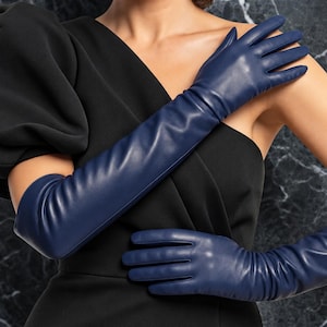 May include: A pair of long, navy blue leather gloves that extend past the elbow. The gloves feature a smooth, matte finish and a fitted design that contours to the hands and arms, providing full coverage from the fingers up to the upper forearm.