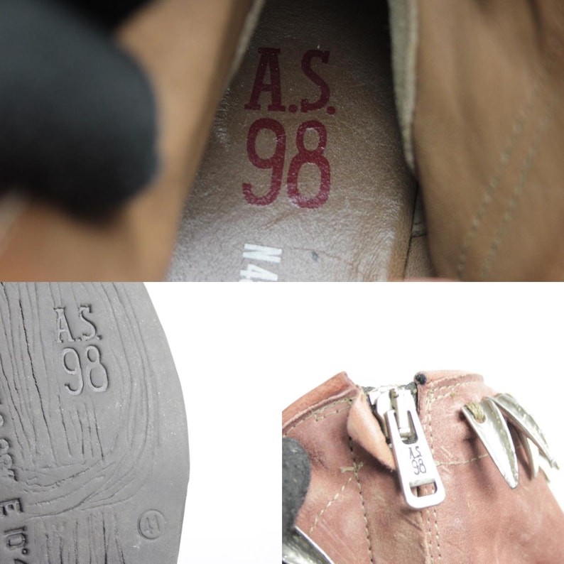 May include: Close-up of a brown leather boot with a zipper and decorative metal accents. The interior shows the text "A.S. 98" in red. The sole of the boot also has the text "A.S. 98".