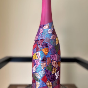 Decorative hand painted wine bottle. Home decor or gift item.