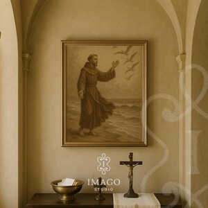 May include: A sepia-toned framed print of a religious figure standing on a beach, reaching towards flying birds. Below, a brass crucifix and bowl sit on a dark wooden surface. The image is displayed in a room with arched architectural details.