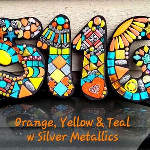 a creative and colorful display made up of various mosaic tiles in the shape of the numbers 5, 1, and 6. The tiles are arranged in a visually appealing manner, showcasing a variety of colors and patterns. The image is described as a collage of multiple images, and it is not a single image but a collection of different images that come together to form the number 5, 1, and 6.