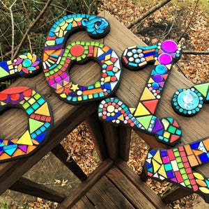a collection of colorful mosaic tiles arranged in various shapes and sizes, creating a visually striking and artistic display.