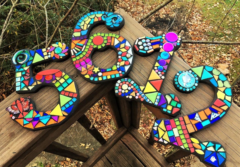a collection of colorful mosaic tiles arranged in various shapes and sizes, creating a visually striking and artistic display.