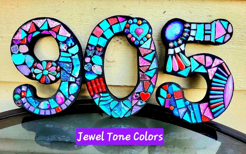 The image is a mosaic-style number 9, 5, and 0, made up of colorful tiles in various shades and patterns.