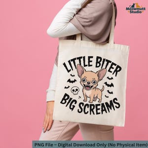 May include: A beige tote bag with the text "LITTLE BITER BIG SCREAMS" and a cartoon chihuahua illustration. The design includes bats and a skull. The bag is held against a pink background.