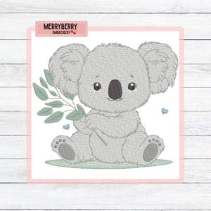 May include: An embroidered design of a grey koala bear holding a sprig of leaves, with two small blue hearts. The koala is sitting on a patch of green grass. The text "MERRYBERRY EMBROIDERY" is in a pink rectangle.