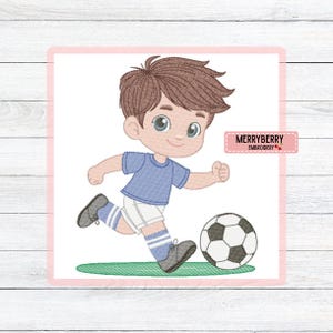 May include: A cartoon illustration of a young boy in a blue shirt and white shorts kicking a soccer ball. The boy has brown hair and is running on a green field. The image includes the text "MERRYBERRY EMBROIDERY".