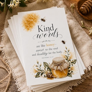 May include: A stack of white cards with the text "Kind words are like honey - sweet to the soul and healthy for the body." The cards feature illustrations of honey, bees, and flowers, with a rustic aesthetic.