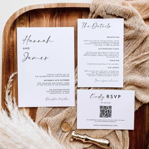 May include: A wedding invitation suite featuring three white cards with black text. The main card displays the names Hannah and James, date, and location. A details card provides reception and accommodation information. An RSVP card includes a QR code.