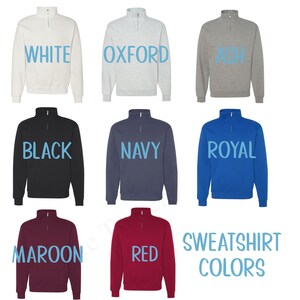 May include: A collection of quarter-zip sweatshirts in various colors: white, oxford, ash, black, navy, royal, maroon, and red. The text "SWEATSHIRT COLORS" is displayed in the bottom right corner.