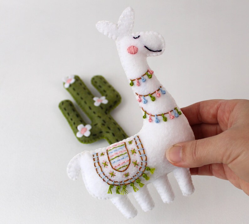 Hand holding a stuffed felt llama