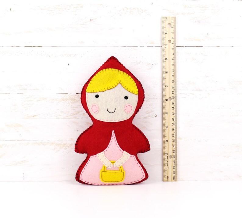 Plush felt Little Red Riding Hood next to a ruler to show size