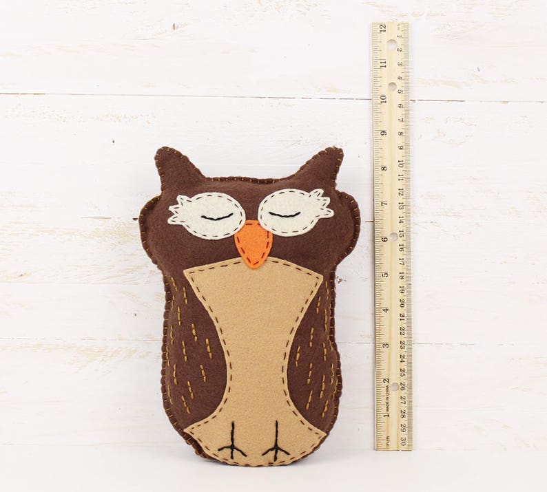 Plush felt owl next to a ruler to show size
