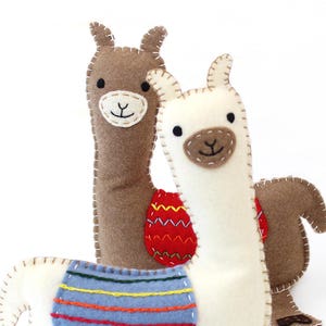 Two felt llamas with hand embellishing