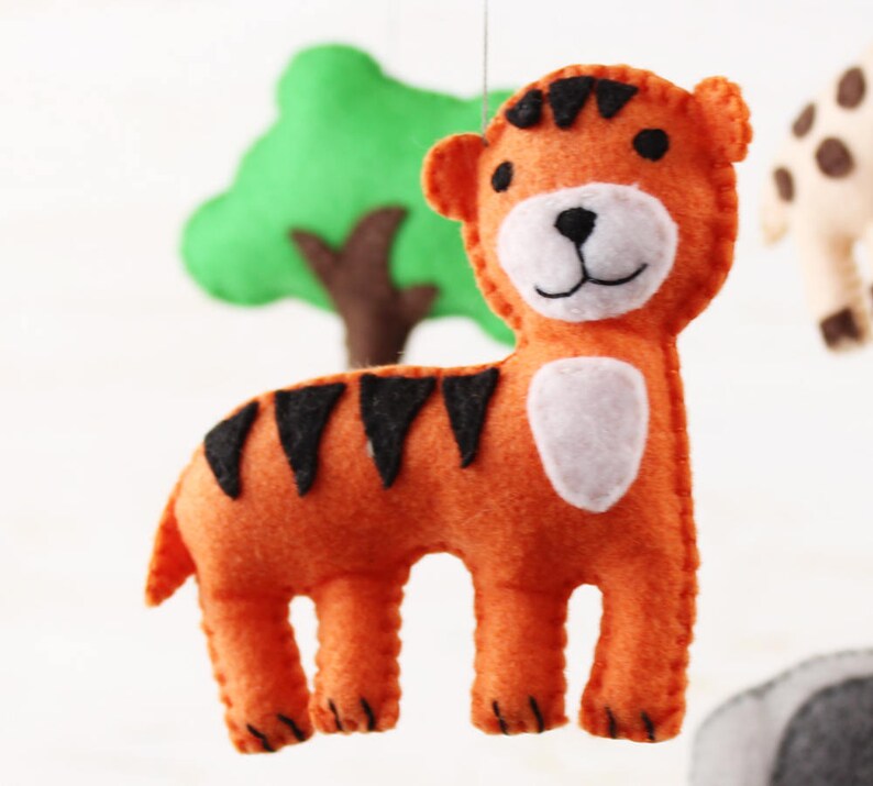 Close up of hand sewn tiger in jungle animals mobile