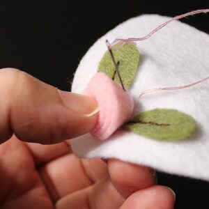 Hand sewing a felt blossom