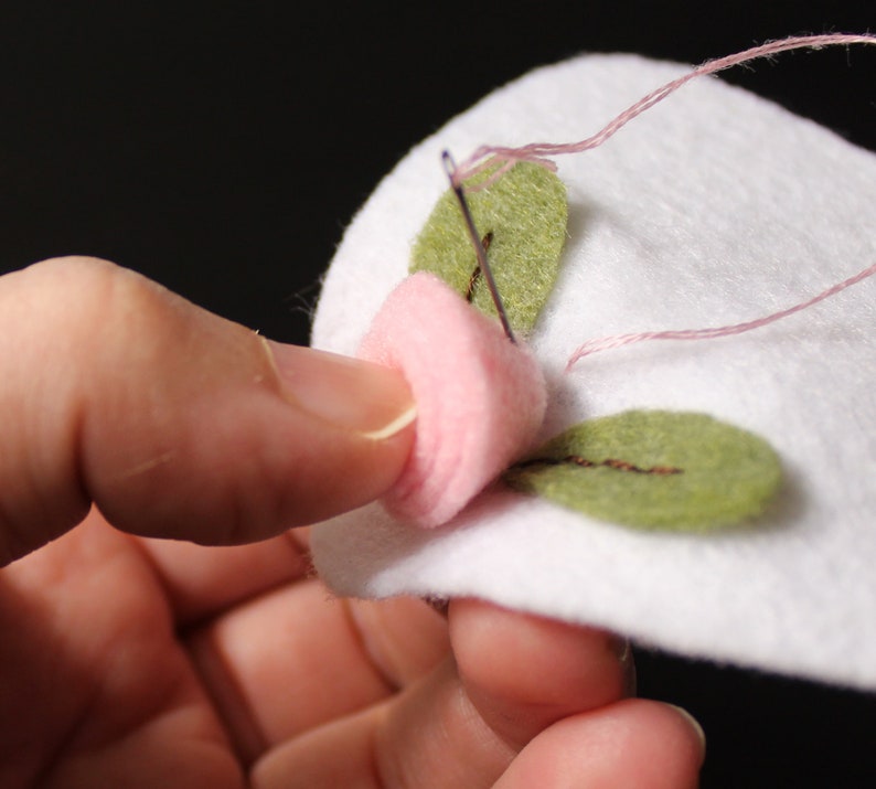 Hand sewing a felt blossom
