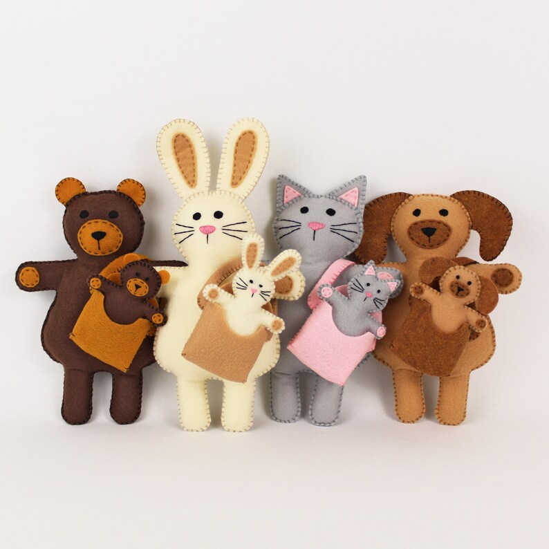 Hand sewn bear, rabbit, cat, and dog, holding babies in carriers