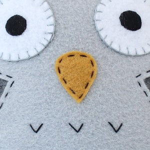 Close up of stitching on owl's face