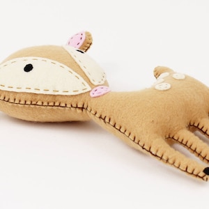 Soft deer plush toy lying on it's back