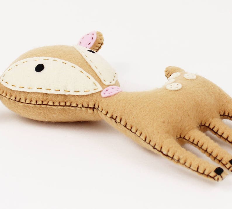 Soft deer plush toy lying on it's back