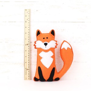 Felt plush fox next to a ruler to show relative size