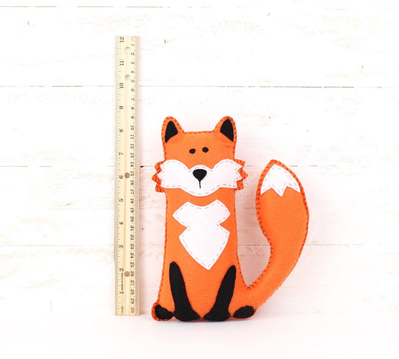 Felt plush fox next to a ruler to show relative size