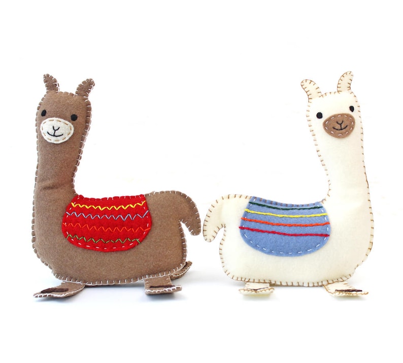 Two hand sewn felt llamas sitting back to back
