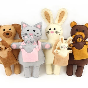 A set of four felt plush animals, a dog, cat, rabbit, and bear, along with baby versions of each animal in carriers