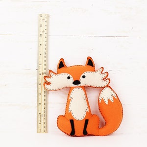 Felt fox next to a ruler