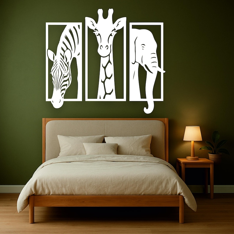 May include: White animal silhouette wall art featuring a zebra, giraffe, and elephant, each within a rectangular frame. The artwork is mounted on a dark green wall above a wooden bed frame with beige bedding. A small wooden side table with a lamp is next to the bed.