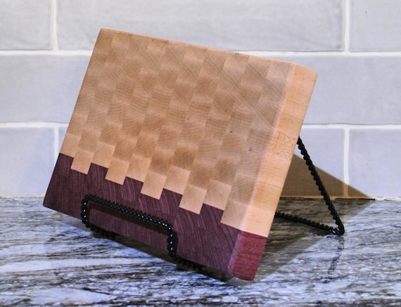 End-grain hard maple meets vivid purple heart wood in a striking two-tone cutting board that's as much wall art as kitchen tool.