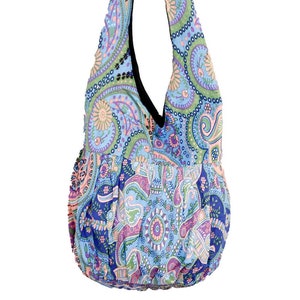 May include: A blue, green, pink, and purple paisley patterned hobo bag with a black strap.