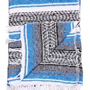 May include: A blue, white, and black striped Mexican blanket with white fringe. The blanket is folded in half and has a woven pattern.