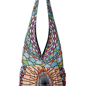 May include: A colorful, patterned shoulder bag with a unique design. The bag features a geometric pattern in shades of blue, green, pink, and orange. The bag's strap is black, and the body of the bag has a rounded bottom.