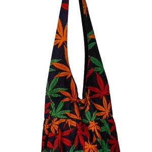 May include: A black shoulder bag with a colorful marijuana leaf pattern. The bag has a long strap and is made of a soft, durable fabric.