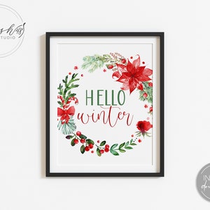 May include: A printable digital download of a watercolor illustration of a Christmas wreath with red poinsettias, berries, and greenery. The wreath surrounds the text "HELLO winter".