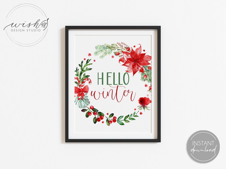 May include: A printable digital download of a watercolor illustration of a Christmas wreath with red poinsettias, berries, and greenery. The wreath surrounds the text "HELLO winter".