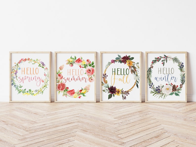 May include: Four framed prints with watercolor floral wreaths and the text "Hello spring", "Hello summer", "Hello fall", and "Hello winter".