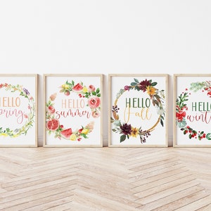 May include: Four framed prints with watercolor floral wreaths and the text "Hello spring", "Hello summer", "Hello fall", and "Hello winter".