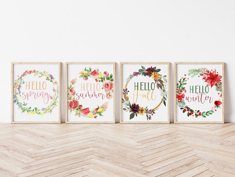 May include: Four framed prints with watercolor floral wreaths and the text "Hello spring", "Hello summer", "Hello fall", and "Hello winter".