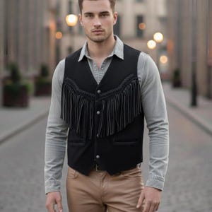 May include: A black vest with fringe detailing, worn over a gray button-down shirt and tan pants. The vest has a classic western design with decorative stitching and button closures. The outfit is completed with a brown belt.