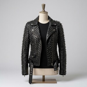 May include: A black leather motorcycle jacket featuring an all-over pattern of sharp, pointed metal studs. The jacket includes a notched lapel, an asymmetrical front zipper closure, a buckled waist belt, and a small zippered pocket on the front.