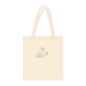May include: Cream-colored tote bag with matching handles. The bag features the text "DON'T WASTE YOUR POTENTIAL" in a dark gray font, along with a small, stylized illustration. The bag is made of a sturdy fabric.