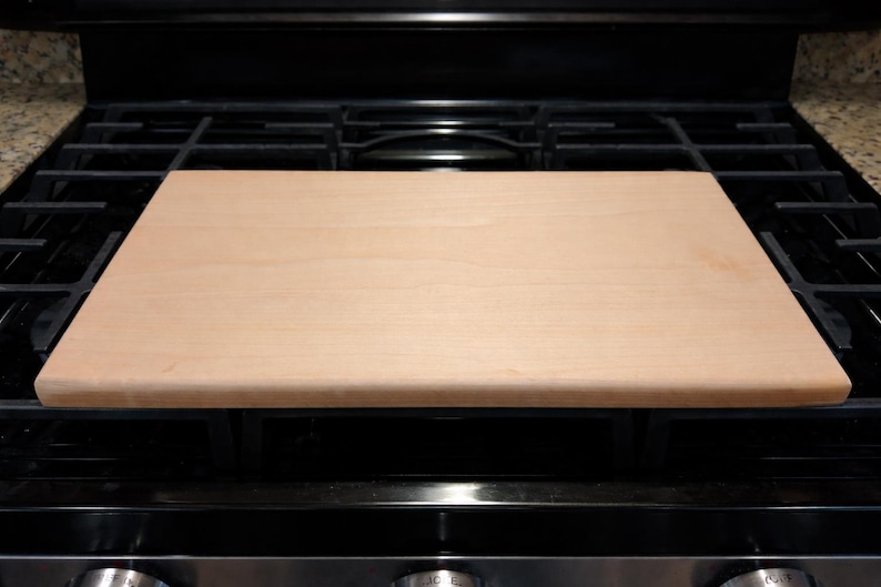 Maple cutting board on a stove top