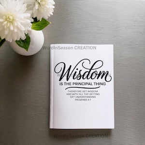 May include: A white book with the words "Wisdom IS THE PRINCIPAL THING" in black script. Below, text reads "THEREFORE GET WISDOM AND WITH ALL THY GETTING GET UNDERSTANDING PROVERBS 4:7". White flowers in a white vase are in the background.