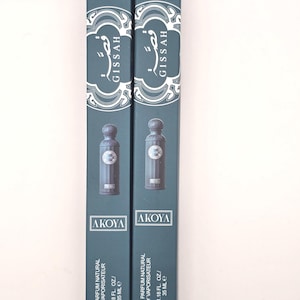 May include: Two teal perfume boxes with the name "GISSAH" in white script. Each box features a small perfume bottle image and the text "AKOYA". The boxes also state "EAU DE PARFUM NATURAL SPRAY VAPORISATEUR 1.18 FL. OZ./ 35 ML e".