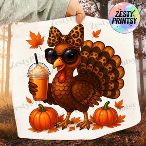 May include: A cartoon turkey wearing sunglasses and a leopard print bow, holding a pumpkin spice latte. Two pumpkins and autumn leaves are at the base. The image has the text "Zesty Printsy" in a circular logo.