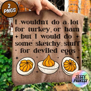 May include: Brown tote bag with the text "I wouldn't do a lot for turkey, or ham but I would do some sketchy stuff for deviled eggs." Features illustrations of deviled eggs. Includes a "Zesty Printsy" logo.