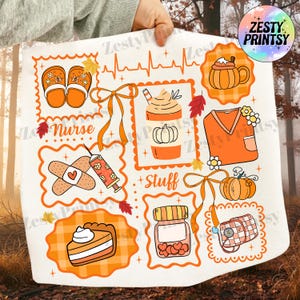 May include: A white square fabric with orange illustrations of fall-themed items, including a pumpkin spice latte, pumpkin, nurse's uniform, and a slice of pie. The word "Nurse" is written on the fabric.